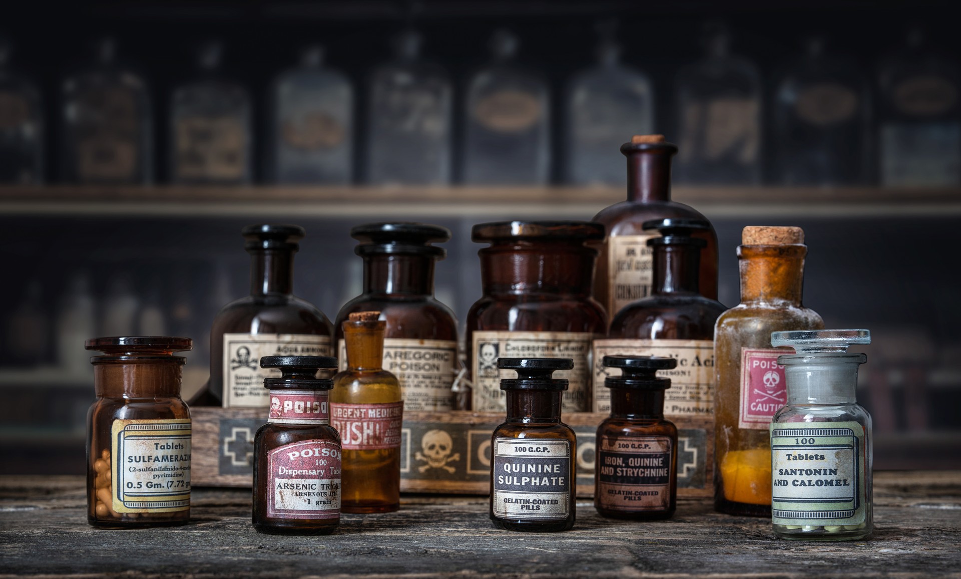 Bottles with drugs from old medical, chemical and pharmaceutical glass. Chemistry and pharmacy history concept background. Retro style.